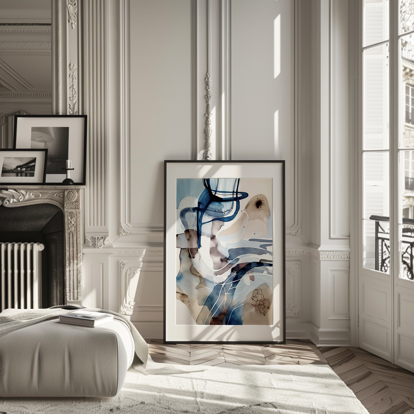 Large framed abstract blue watercolor wall art leaning in a modern living room next to a fireplace.