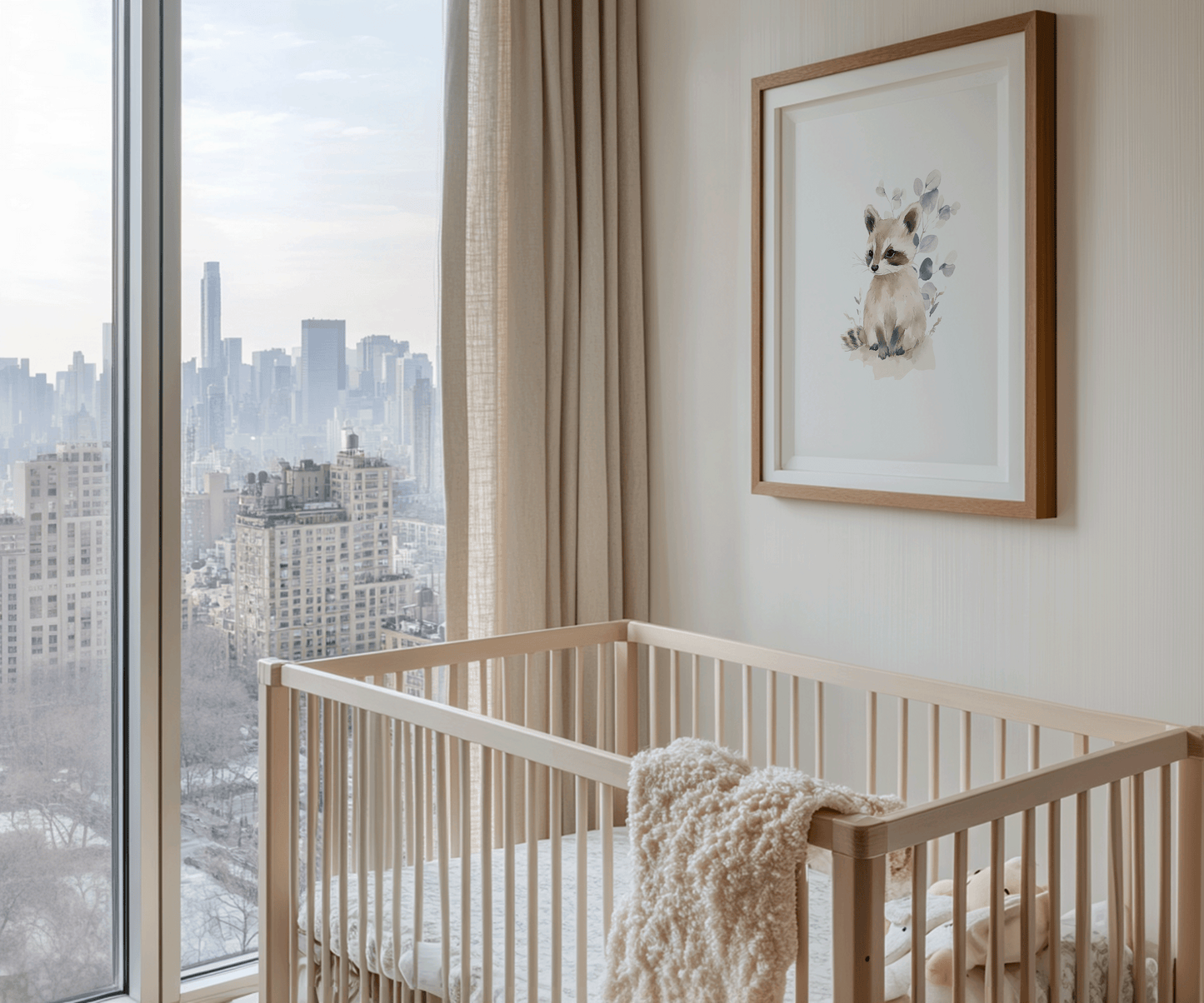Woodland raccoon art print framed in a brown wooden frame, styled above a nursery crib in a neutral baby nursery