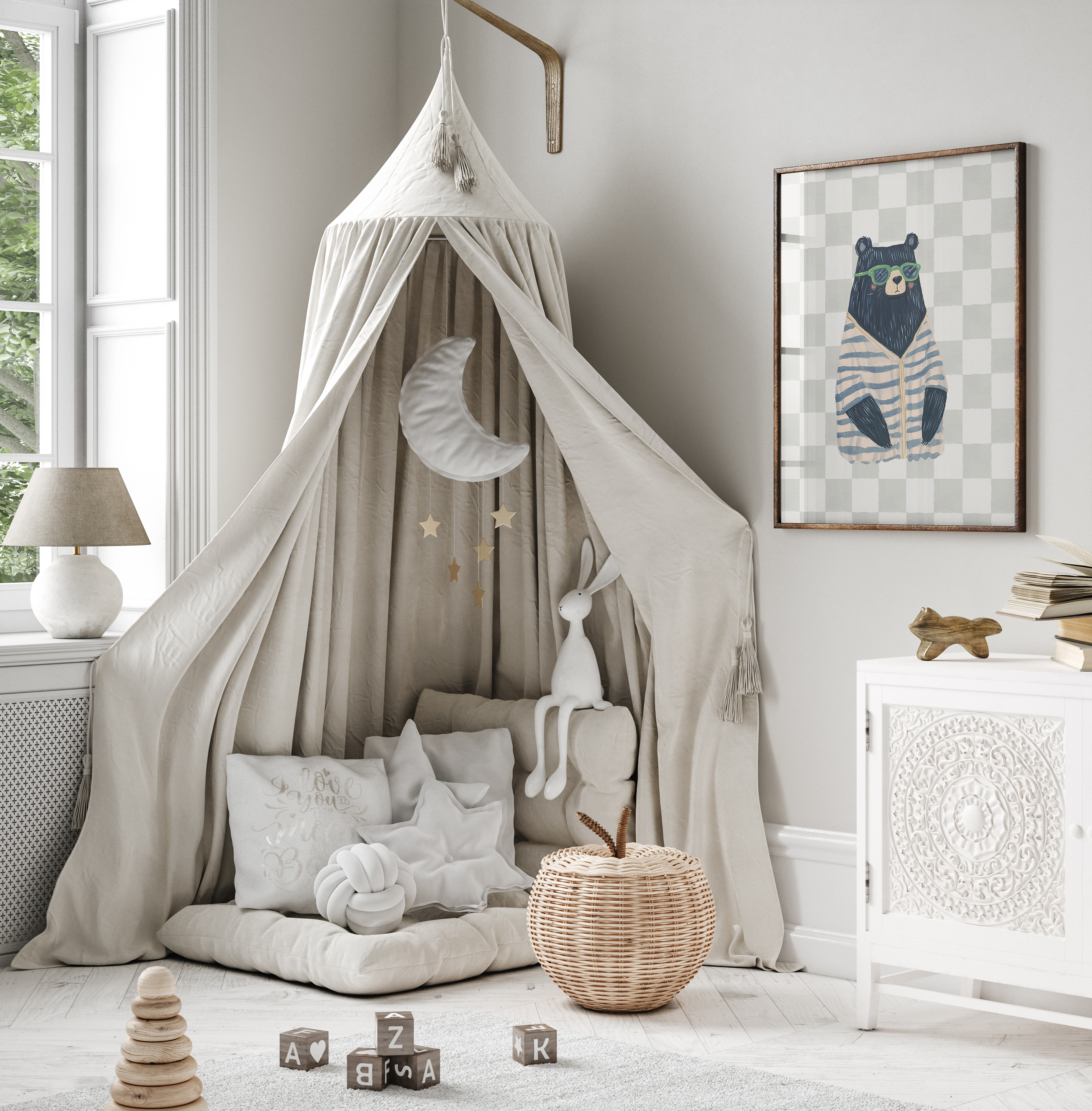 Framed bear nursery wall art print with sunglasses and striped sweater, styled above a beige canopy tent reading nook with pillows and toys. Modern boys’ nursery or playroom wall decor.