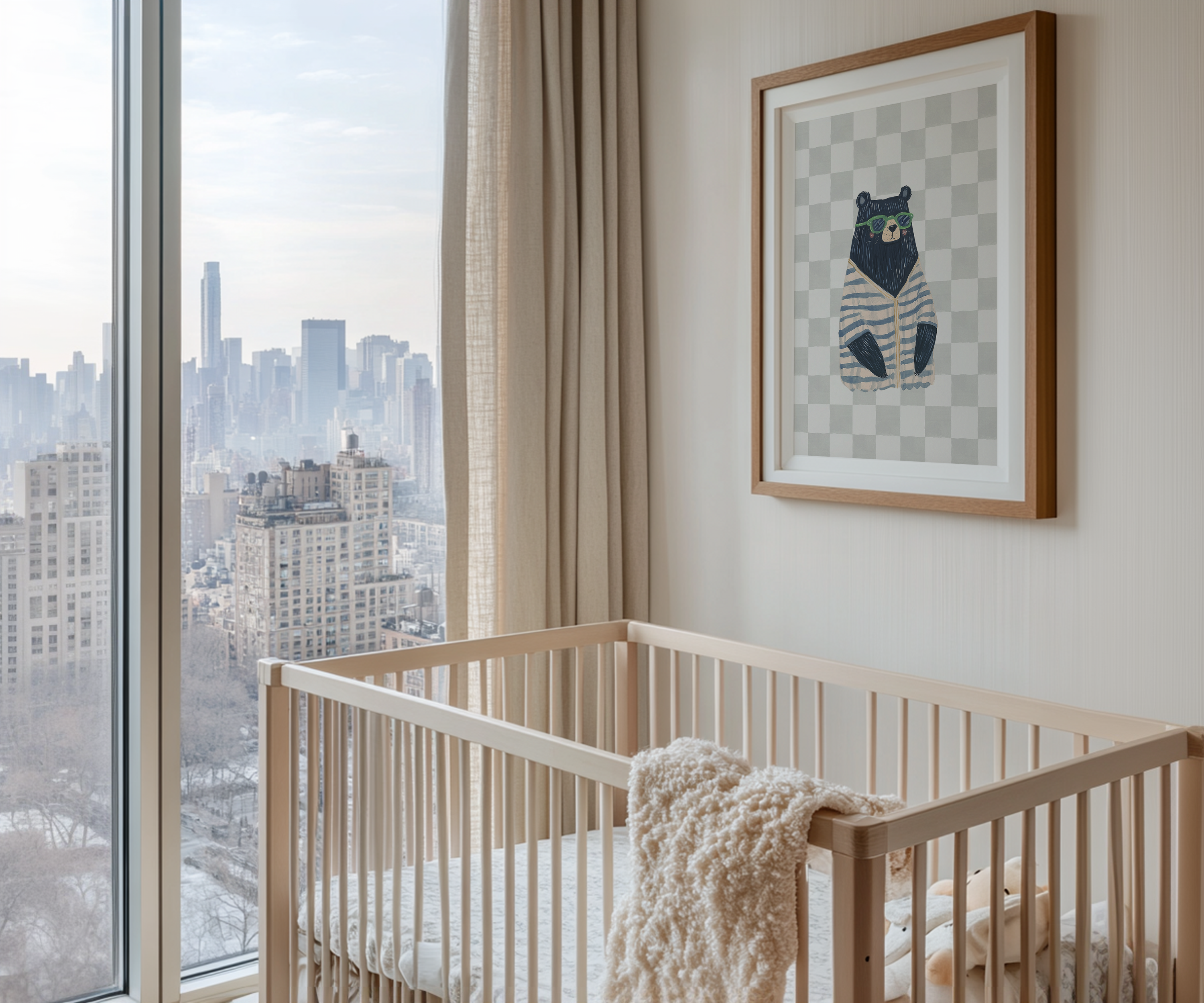 Framed bear nursery wall art print with sunglasses and striped sweater, styled above a wooden crib in a modern nursery with large window and city skyline view. Perfect boys’ bedroom or playroom wall decor.