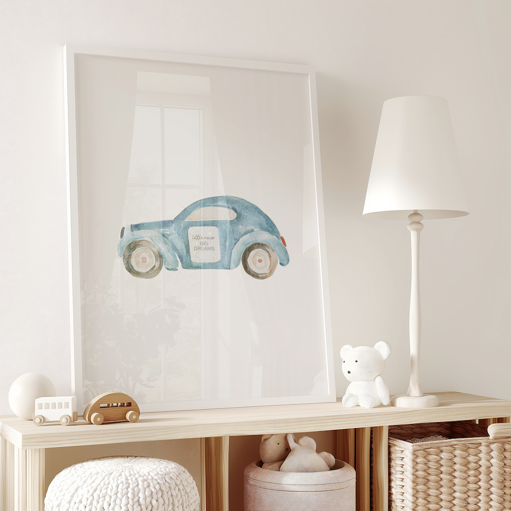 Blue car nursery wall art print with the words ‘Little racer big dreams,’ styled in a boys’ nursery above a wooden storage unit with toys and decor. Perfect framed fine art paper or canvas print for boys’ bedrooms and playrooms.