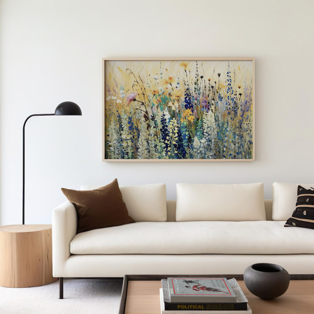Colorful abstract wildflower wall art print with purple, green and yellow florals framed above white sofa in modern living room