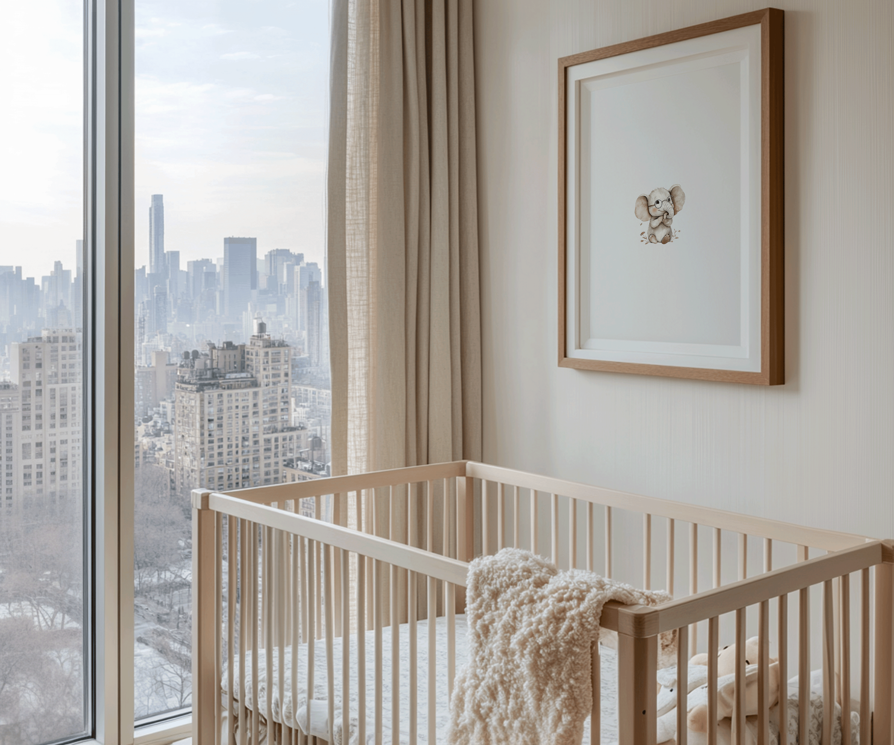 Soft elephant print on the wall in a neutral-toned baby boy nursery with plush baby blanket