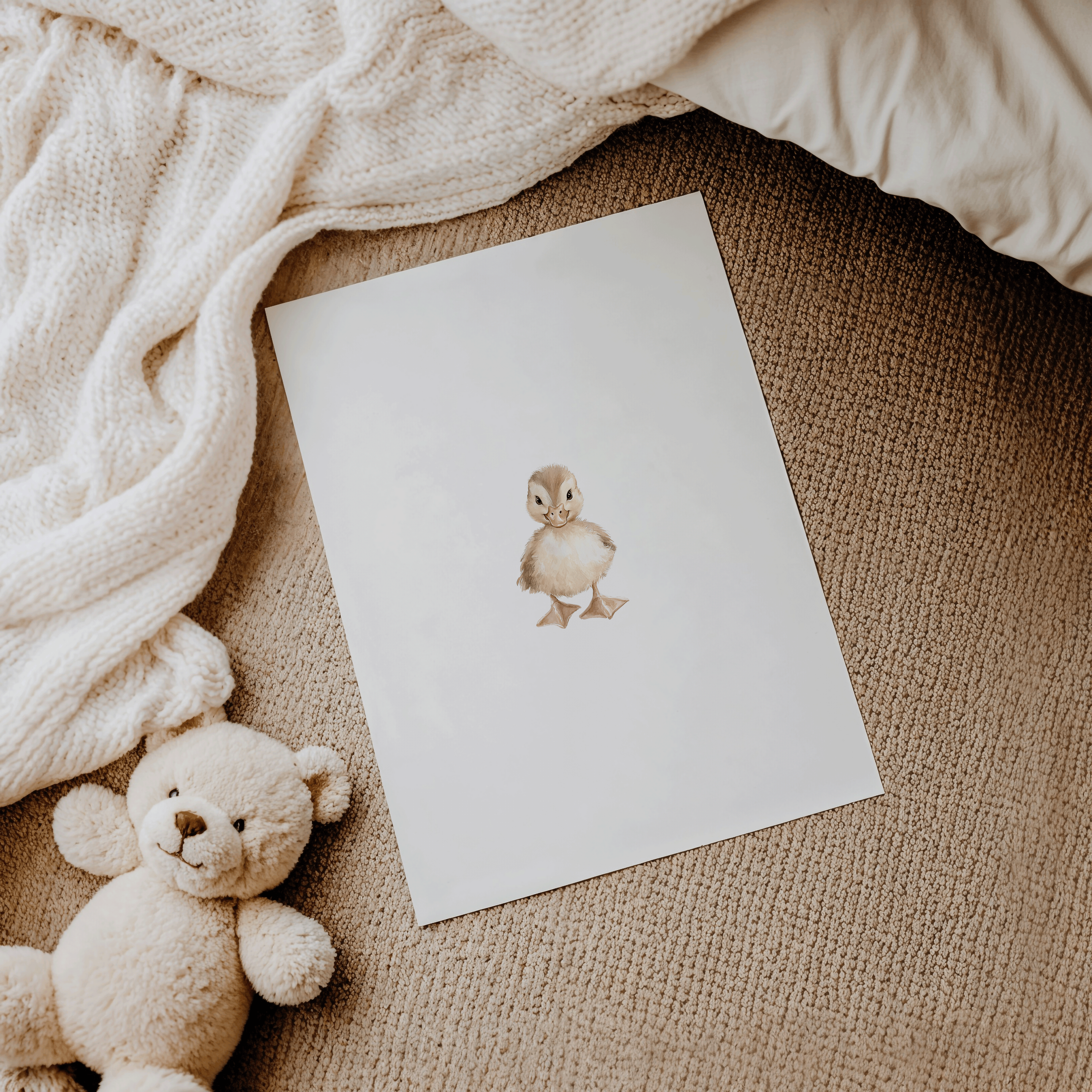 Fine art paper print of a woodland nursery print showing a baby duck unframed and on the floor