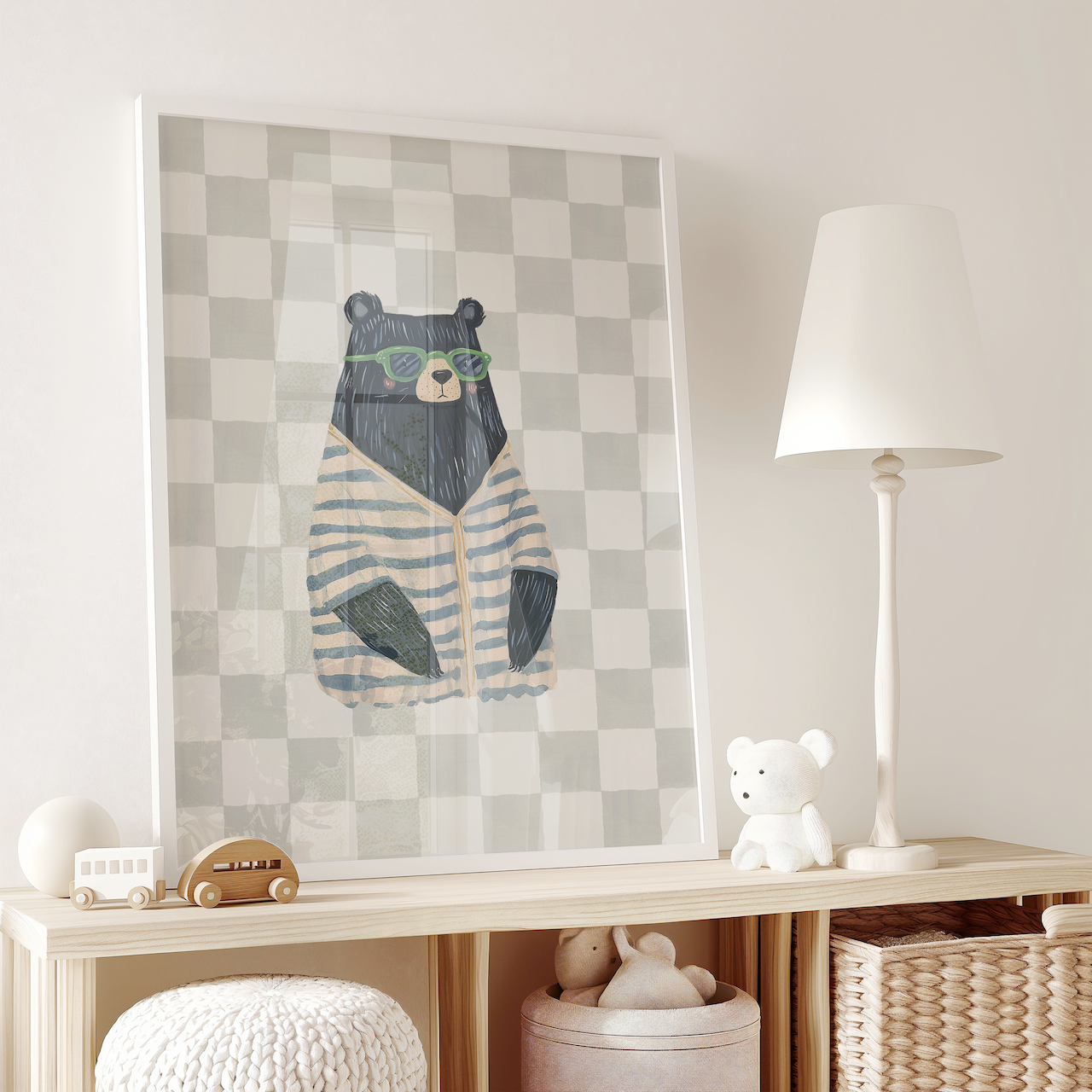 Framed canvas wall art print of a vintage preppy watercolor bear with glasses on and a neutral plaid or checkered background in a kids playroom over a wooden shelf with toys