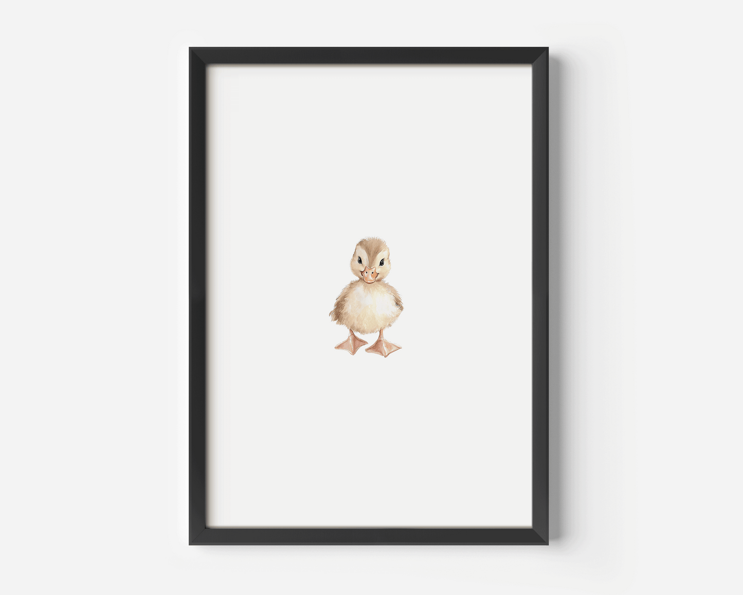 Framed woodland nursery wall art in black wood frame displayed on a white wall