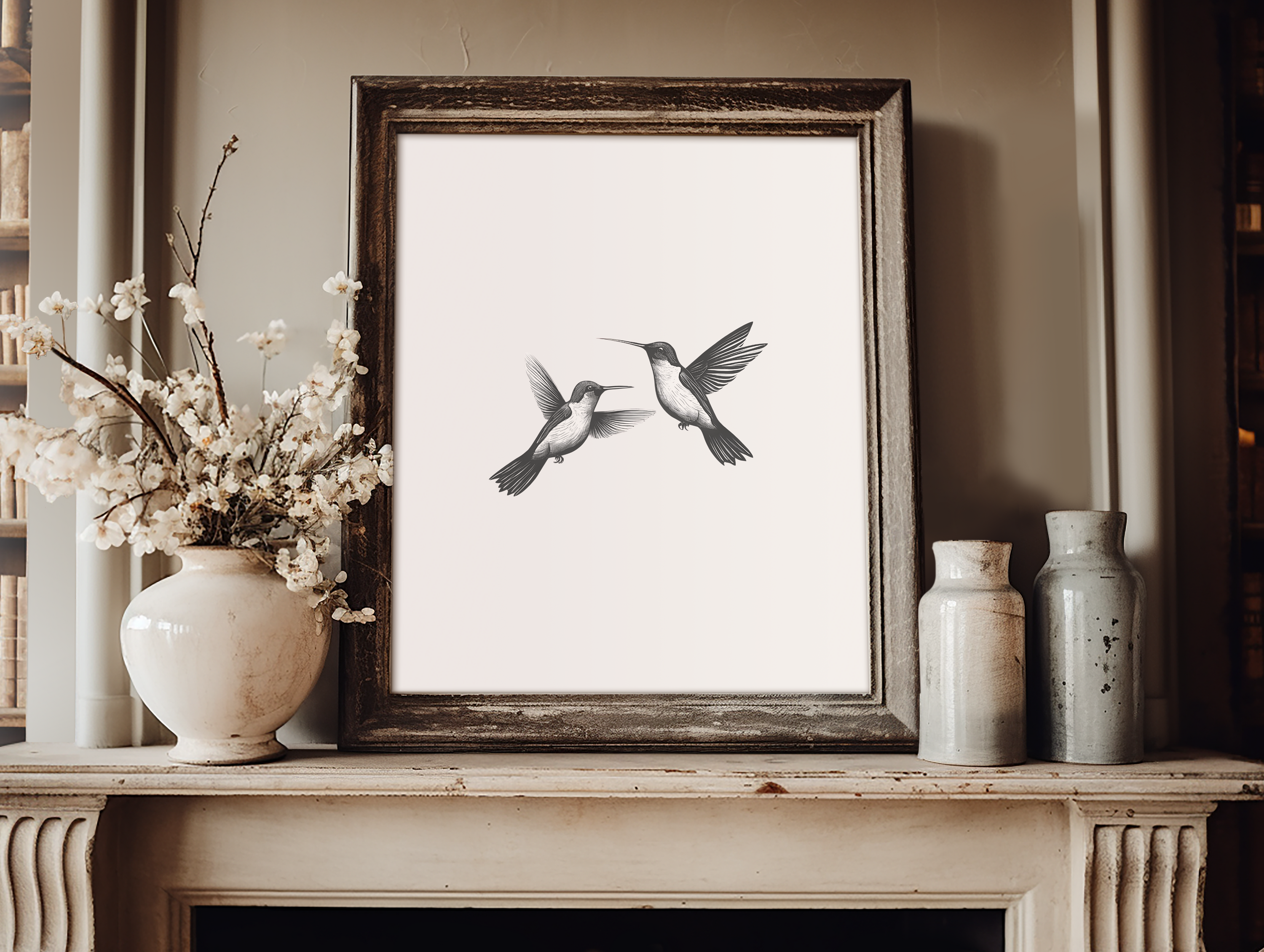 Minimalist hummingbird wall art in black and white framed print displayed on a mantel with rustic vases and floral decor