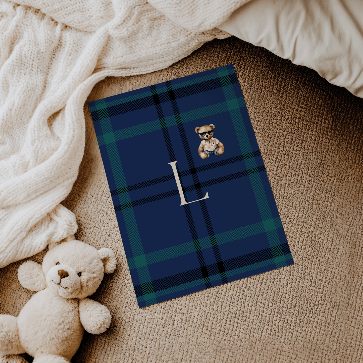 Navy plaid baby room decor with monogrammed letter L and illustrated teddy bear