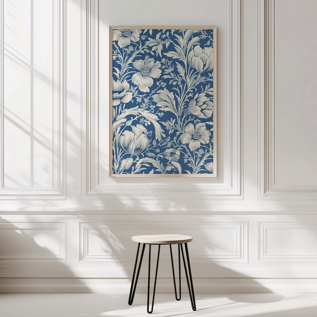 Framed floral artwork on a wall with a small stool in front