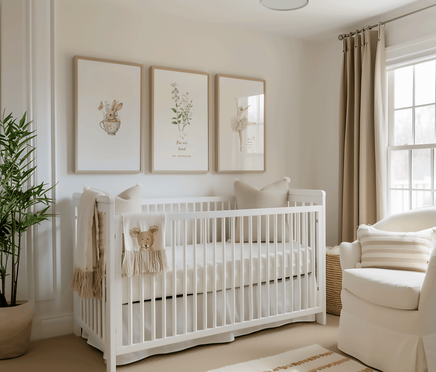 set of 3 framed vintage nursery wall art prints above a white crib in a neutral, minimal nursery for a little girl. the artwork features a sweet vintage baby bunny rabbit in a muted green teacup, wildflowers with quote "you are loved my sunshine", and a vintage beige ballerina in a tutu and the quote "you're born to stand out honey".