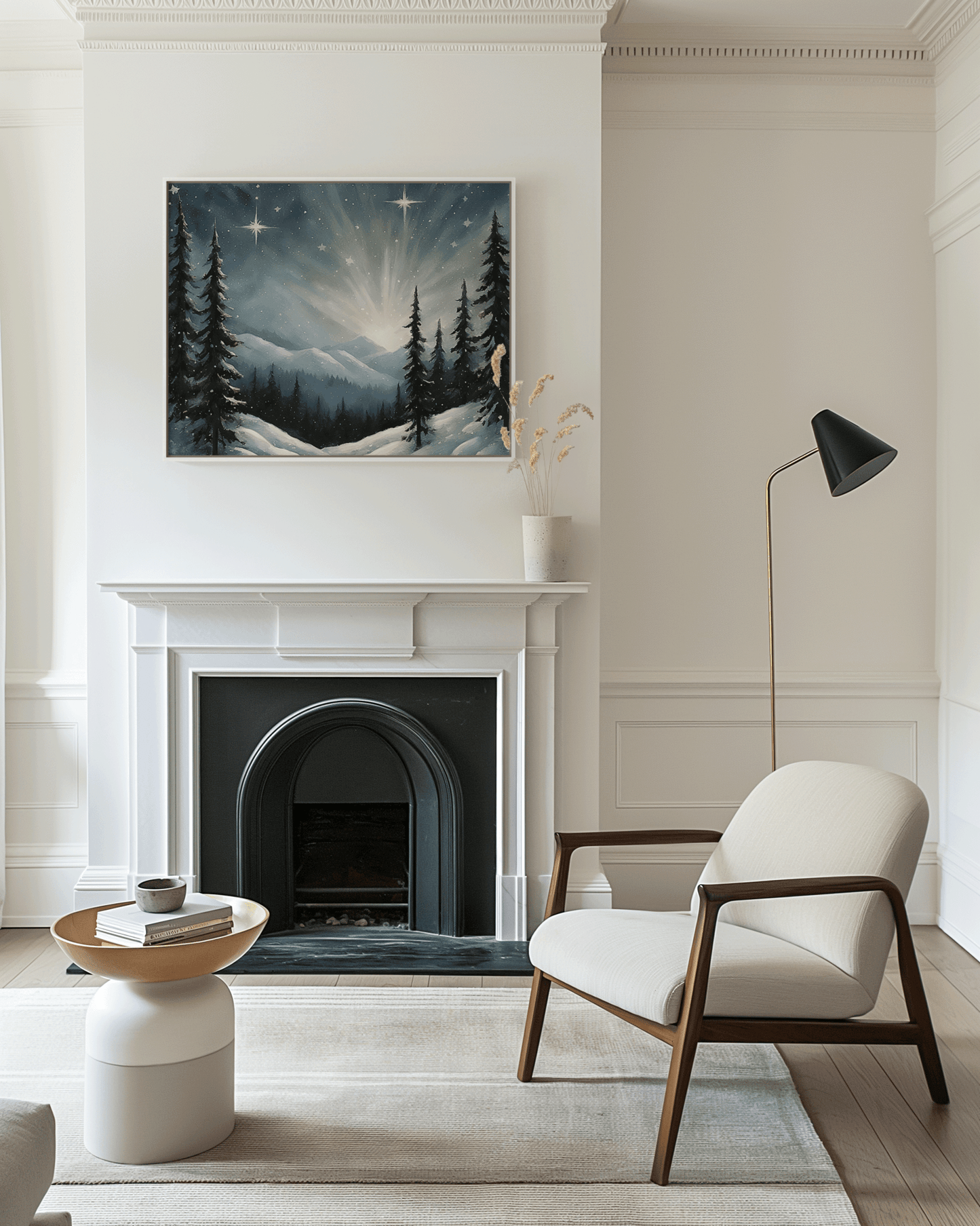 Framed starry winter night Christmas wall art with snowy mountain scene and glowing stars, displayed above a white fireplace in a neutral modern living room with soft natural light.