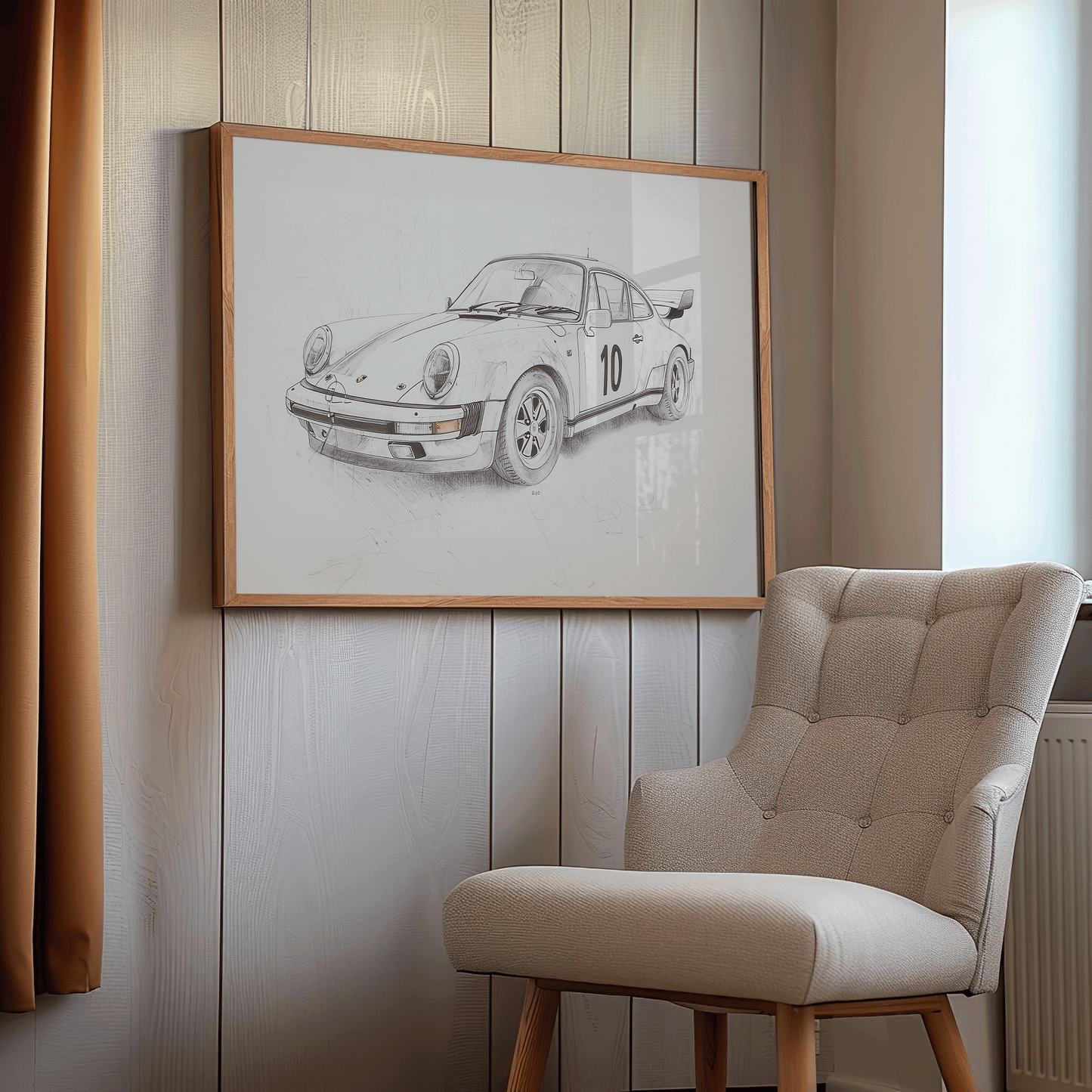 Framed vintage Porsche 911 race car sketch displayed on wood panel wall beside a beige armchair in a cozy reading nook or office
