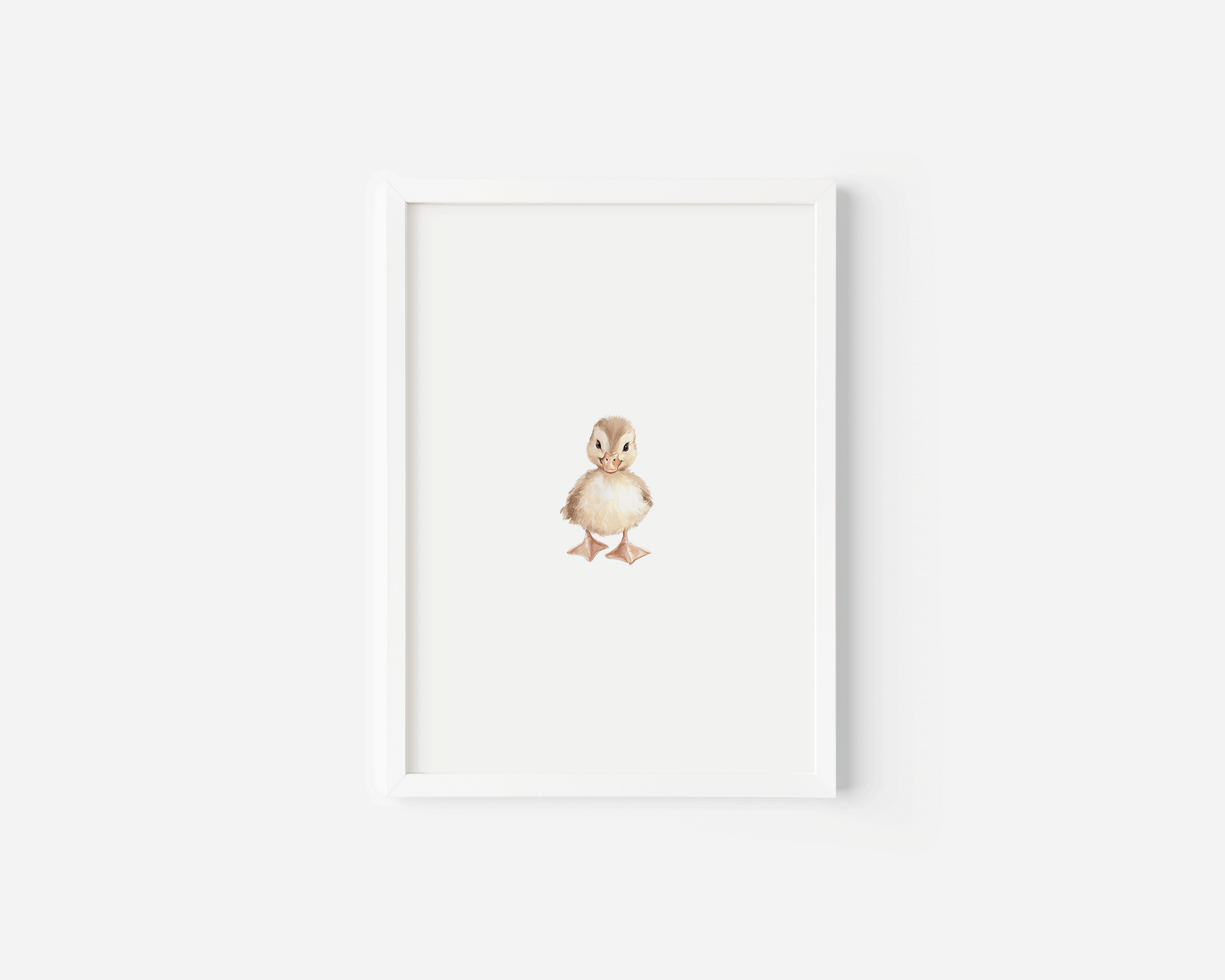 Framed woodland nursery wall art in white wood frame displayed on a white wall