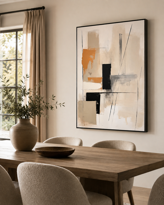 Warm neutral abstract canvas in a black float frame displayed above a dining table in a modern dining room