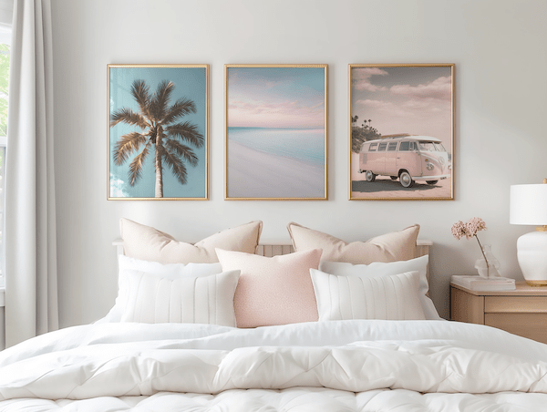 Framed canvas art hung evenly above a bed, showing a damage-free wall art layout in a modern bedroom