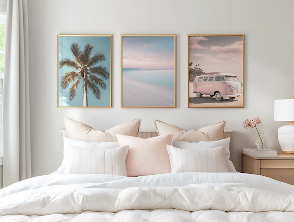 Framed canvas art hung evenly above a bed, showing a damage-free wall art layout in a modern bedroom