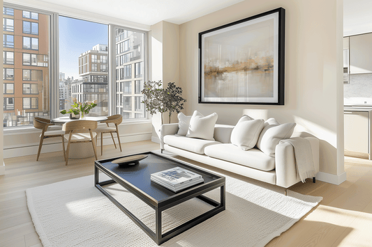 Home staging wall art — large neutral and gold abstract print above a sofa in a bright modern living room
