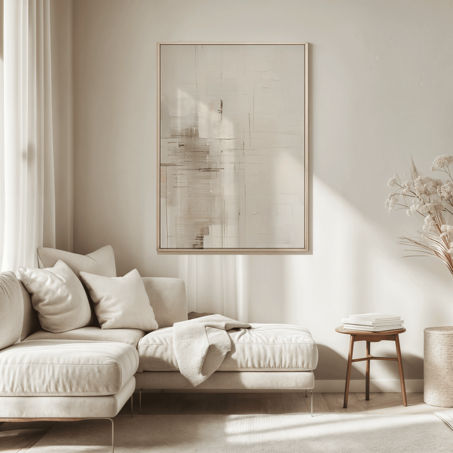 large neutral abstract framed canvas wall art above a beige sectional sofa in a living room
