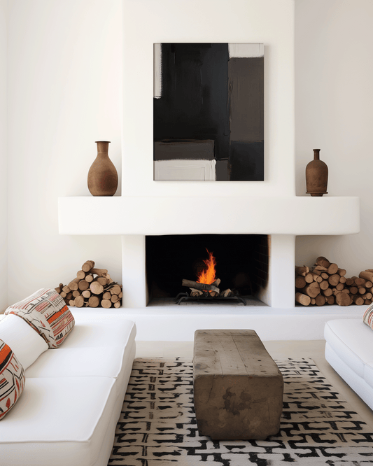 Modern unframed canvas wall art above a fireplace in a minimalist living room with white furniture and neutral tones