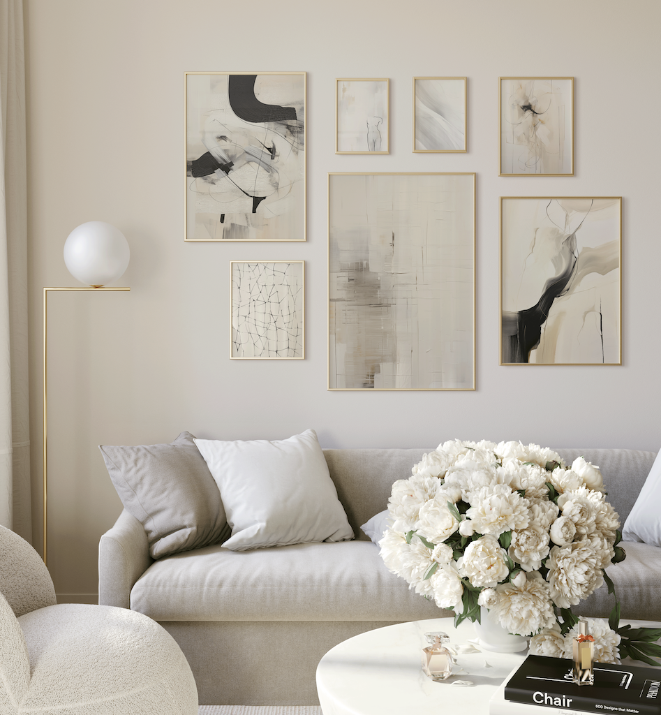 Neutral living room with framed wall art hung above a sofa, demonstrating the ideal 2/3 rule for artwork placement.