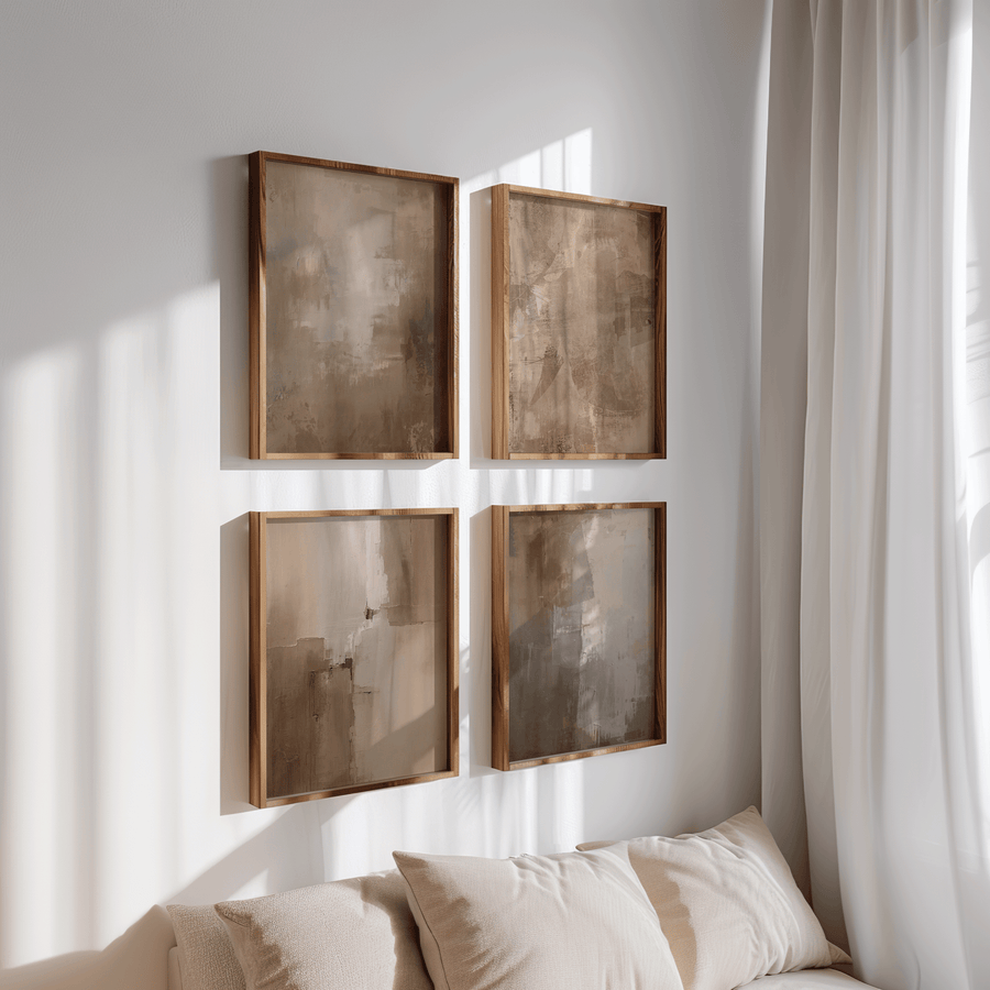 Framed neutral wall art arranged in a balanced grid above a sofa, demonstrating proper spacing and placement for wall art.