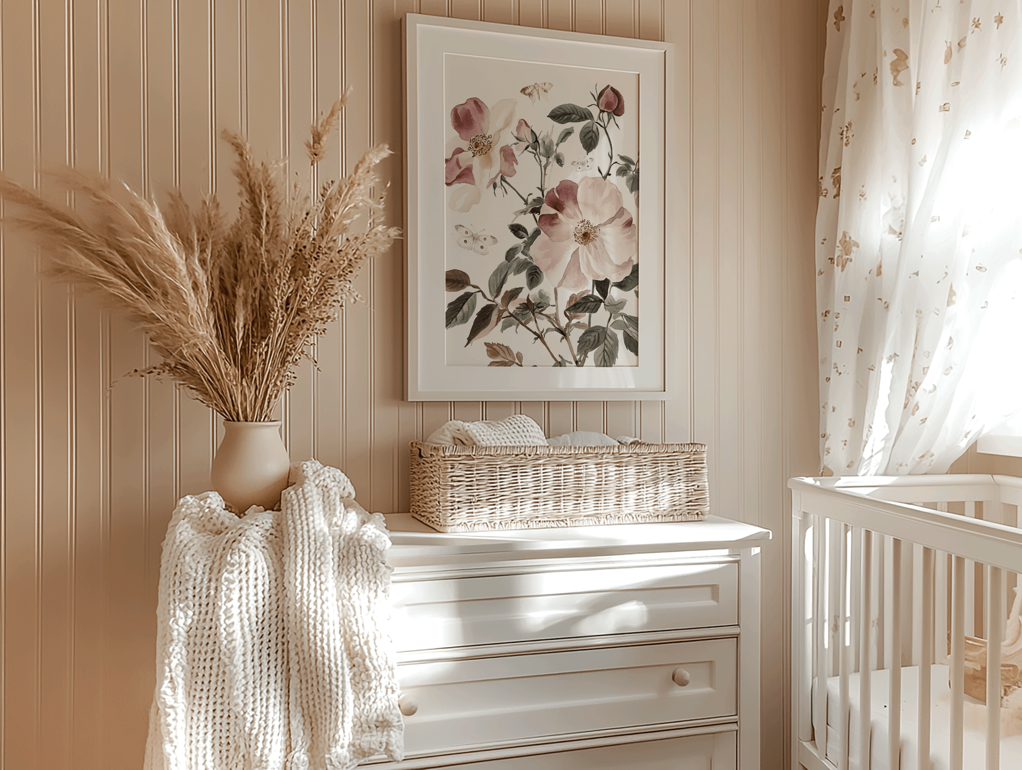 Nursery wall art placement above dresser with framed botanical print, pampas grass, and crib in neutral tones
