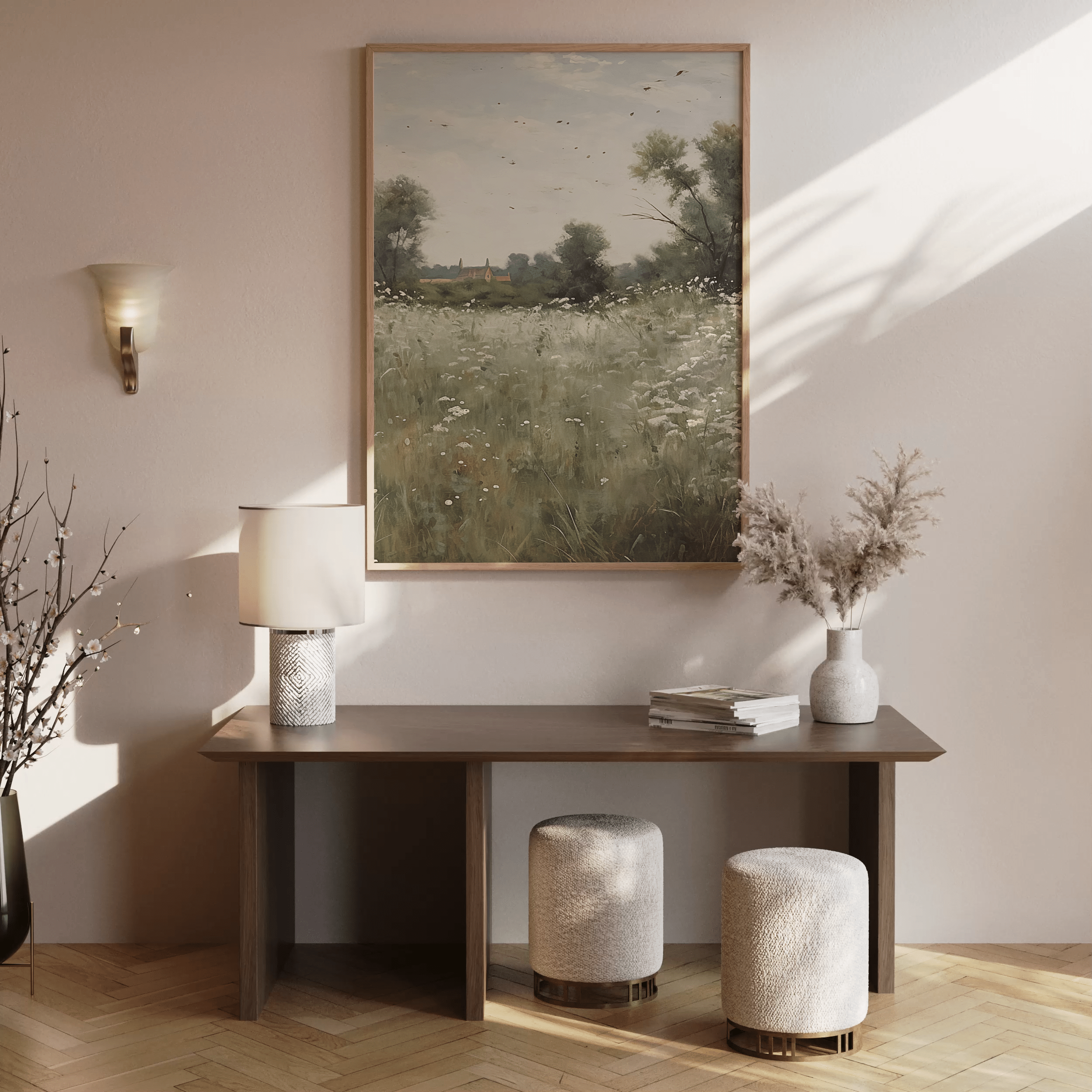 Vintage countryside wall art of a meadow and farmhouse framed above a wooden entryway table