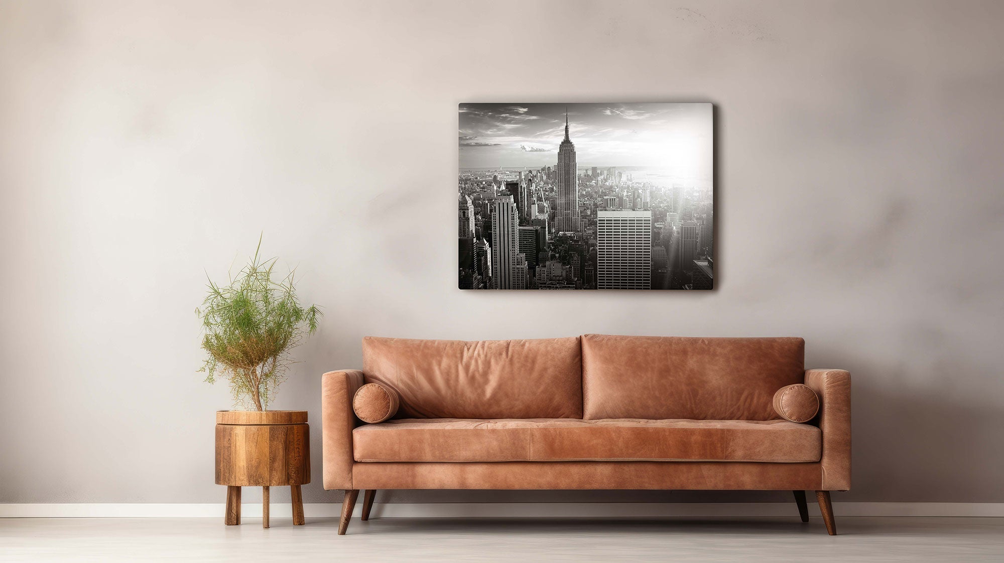 modern room with leather camel brown couch and a black and white image of new york city on the wall as wall art