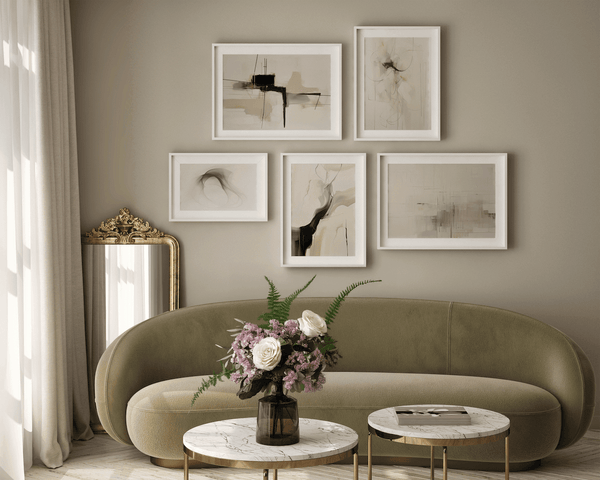 Neutral wall art prints in beige and white framed canvas styled in a modern living room above a green sofa, creating a timeless gallery wall