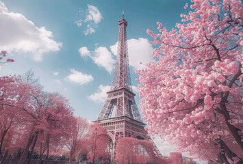 Eiffel tower with cherry blossom trees in full bloom in Paris, on a sunny day