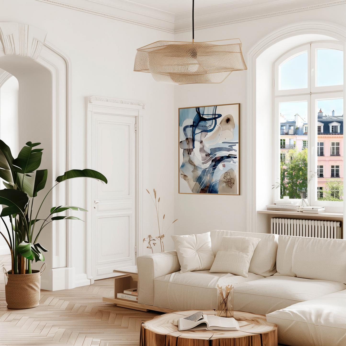 Blue and white abstract wall art framed and styled in a bright modern living room