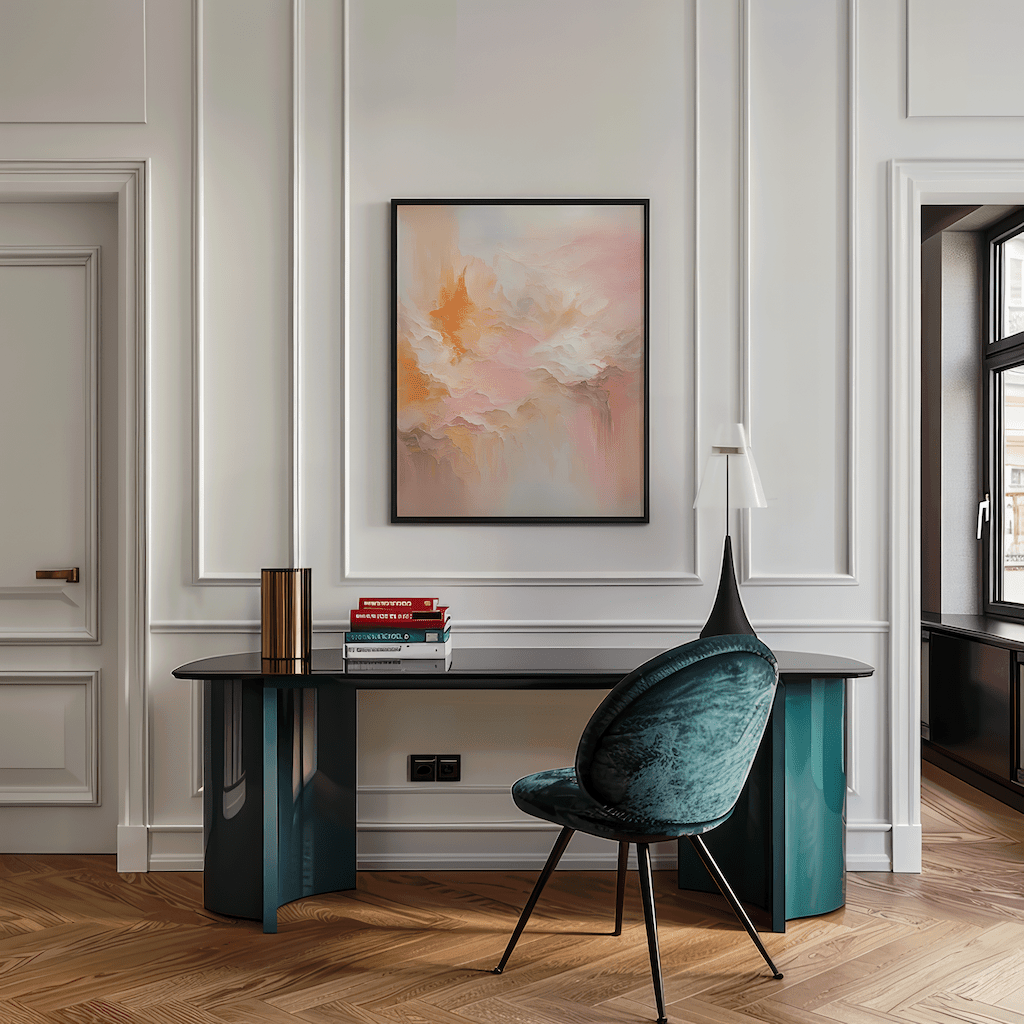 Blush pink and orange abstract wall art framed in black above sleek home office desk