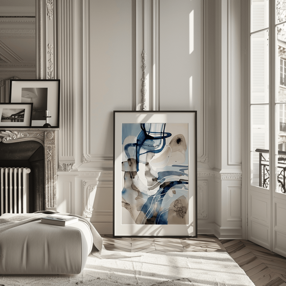 Large framed abstract blue watercolor wall art leaning in a modern living room next to a fireplace.