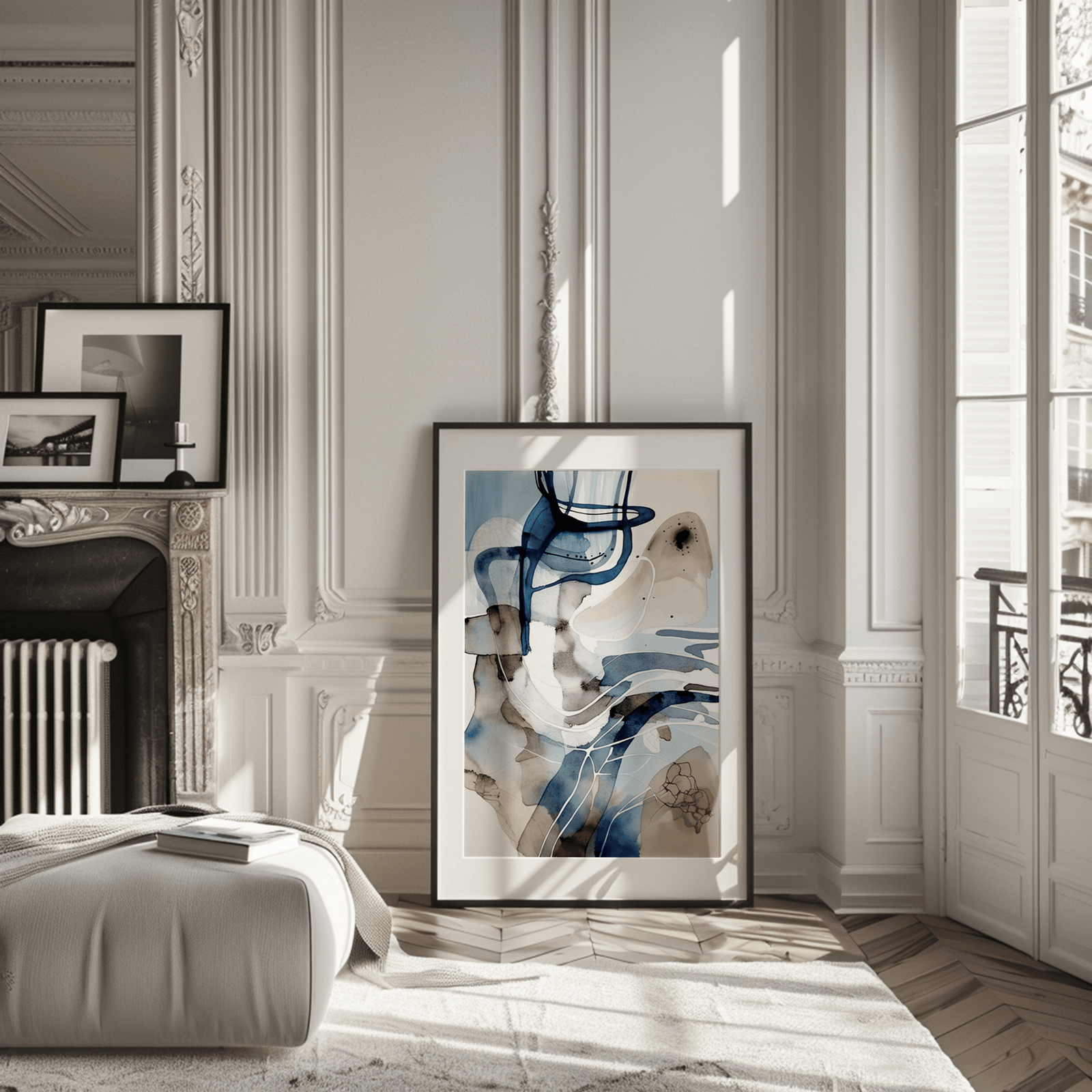 Large framed abstract blue watercolor wall art leaning in a modern living room next to a fireplace.