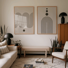 Set of arch and wave line-art prints in wood frames above a bench in a mid-century living room
