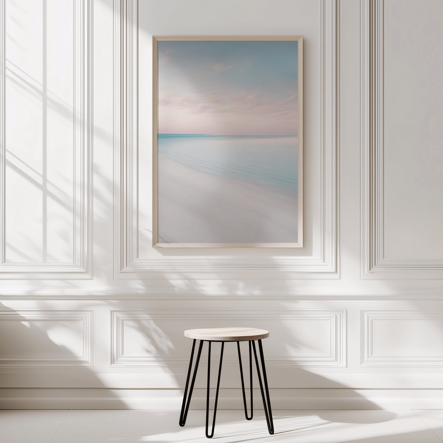 Beach wall art in natural frame displayed in a minimalist white panelled room