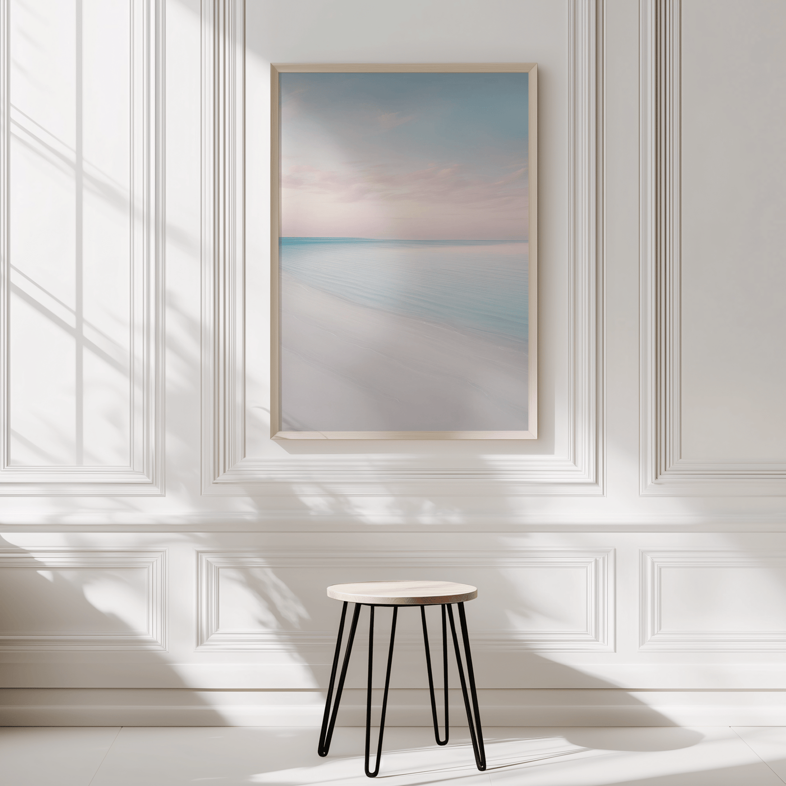 Beach wall art in natural frame displayed in a minimalist white panelled room