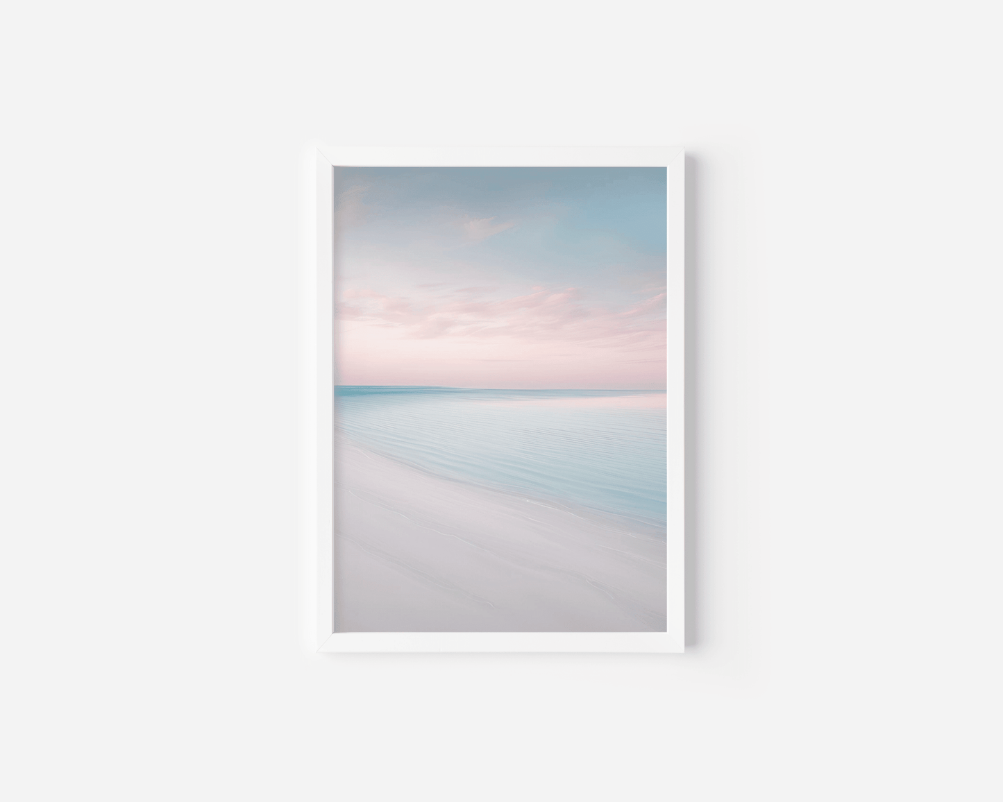 white framed wall art of a beach with a blue sky and pink clouds on a white background