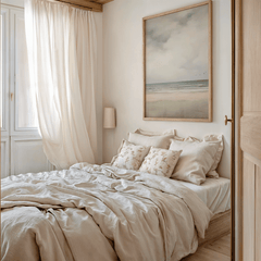 Vintage bedroom with beige bedding and abstract beach coastal framed wall art above bed.