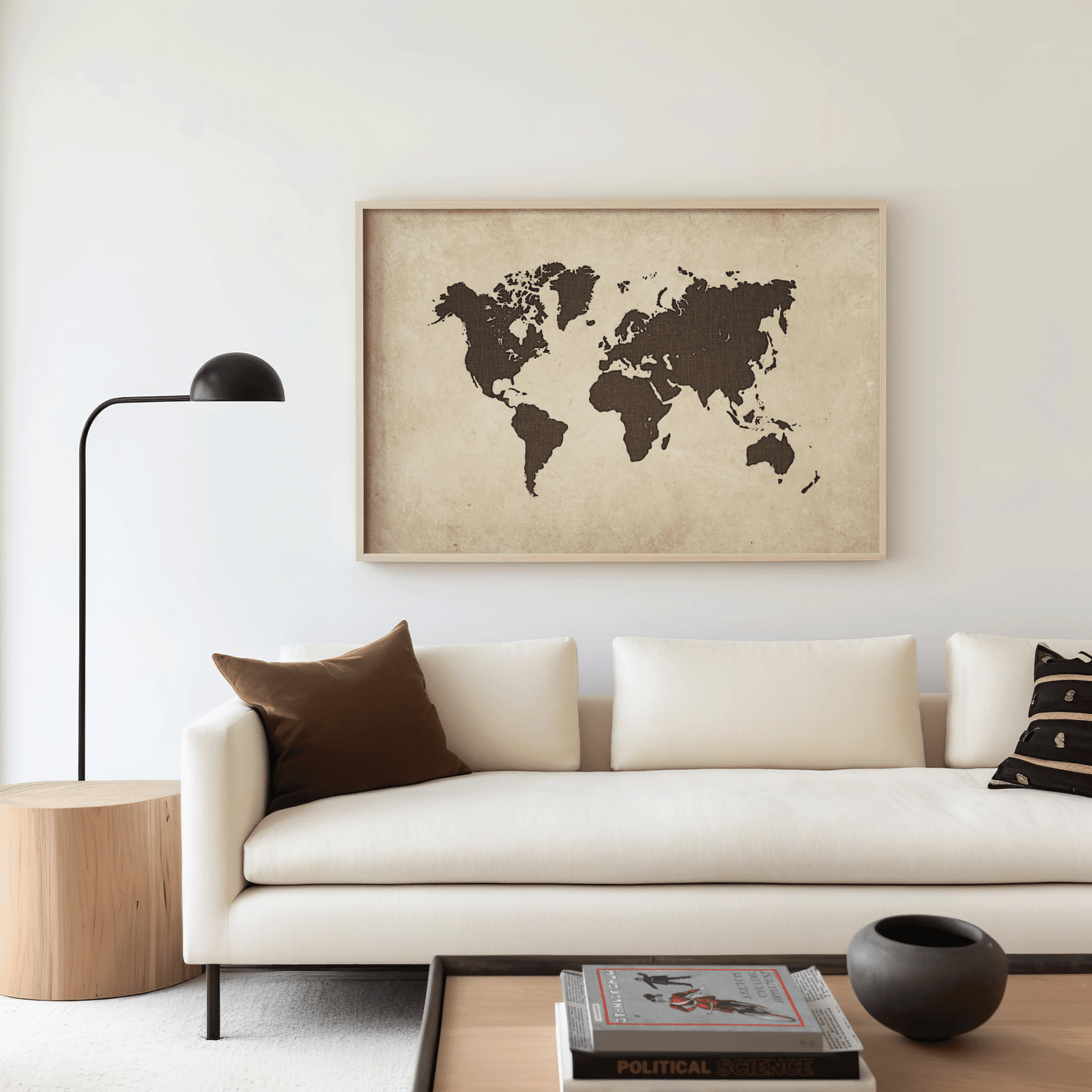 Beige and brown antique-style world map framed over a cream sofa in a modern, minimal living room