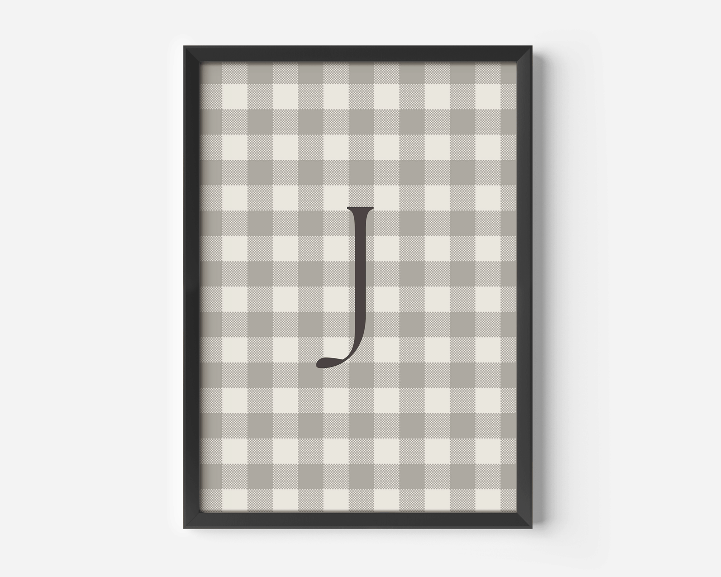 close-up of personalized beige gingham wall art with letter J, black matte frame modern nursery print for boys