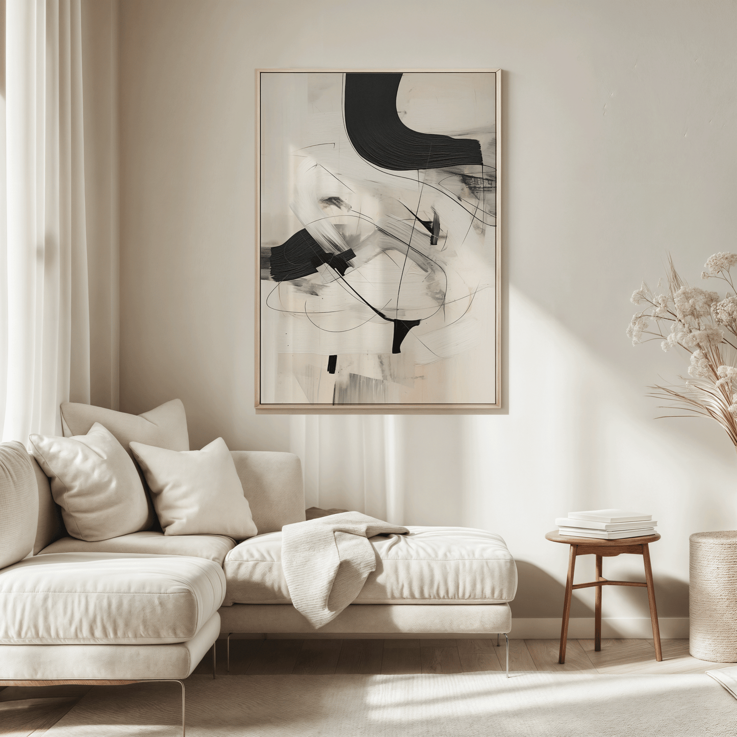 Framed black and beige abstract artwork with faux brushstrokes over a sectional sofa on a warm beige wall in a living room.