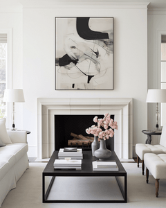 Large black and beige abstract brushstroke wall art framed above a white fireplace