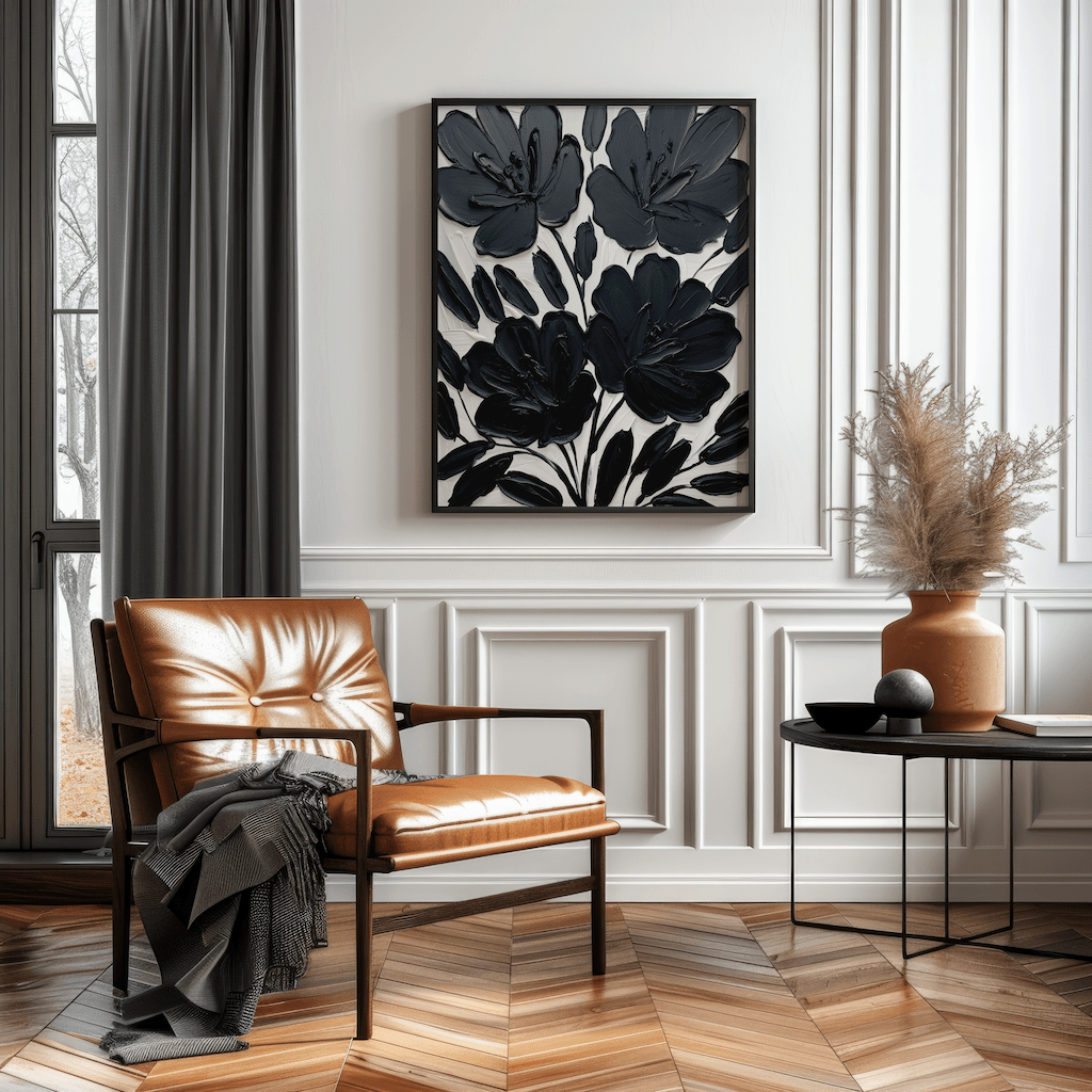 Large black floral wall art framed canvas styled above leather chair in contemporary living room with wood floors