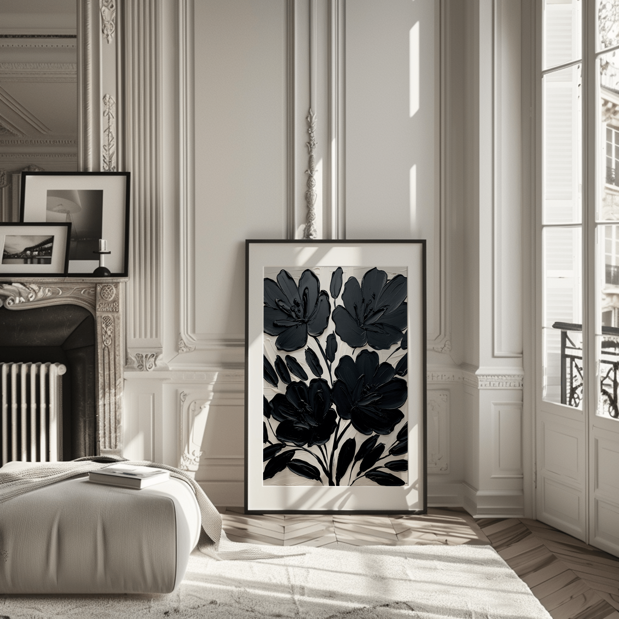 Large black floral wall art print leaning against wall in modern living room with natural light