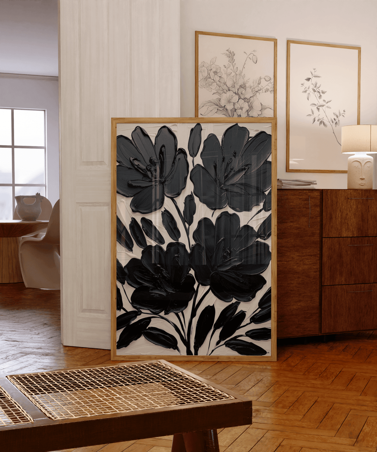 Modern black floral wall art framed canvas featuring oversized abstract flowers styled in home interior