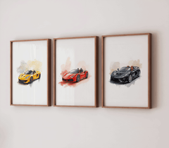 Gallery wall of three watercolour sports car prints in brown wooden frames, featuring the black car