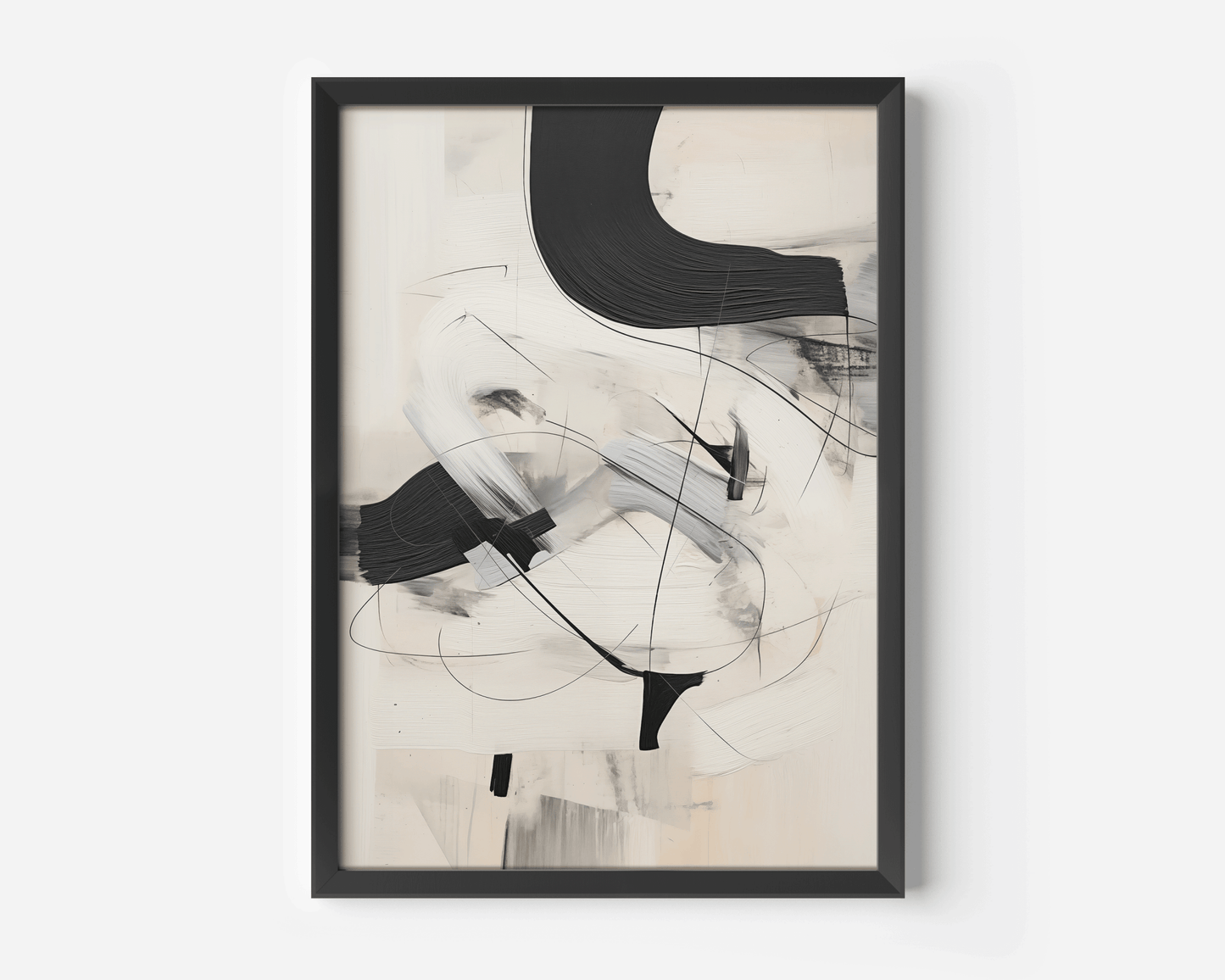 Close-up of a framed black and white minimalist abstract art print with sweeping brushstrokes on a neutral background.