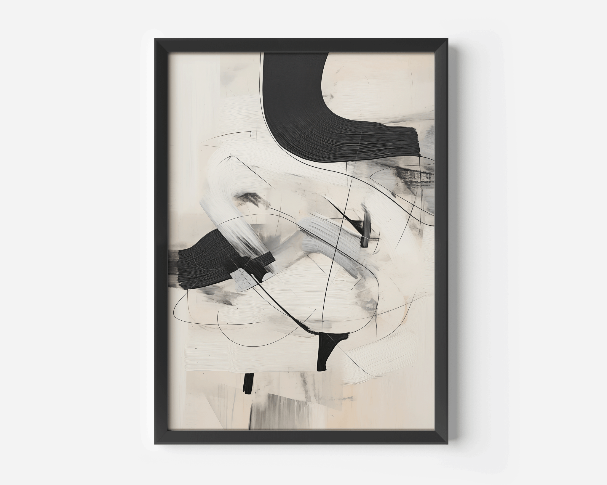 Close-up of a framed black and white minimalist abstract art print with sweeping brushstrokes on a neutral background.