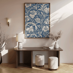 Blue and white chinoiserie print above a dark wood console with a lamp and stools